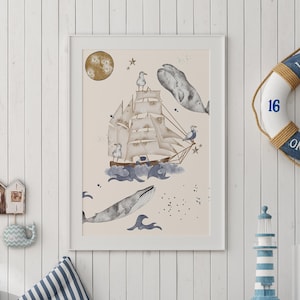 May include: A framed illustration of a ship sailing on the ocean with whales and seagulls. The illustration is on a light pink background with a white frame. The illustration is hanging on a white wood wall.