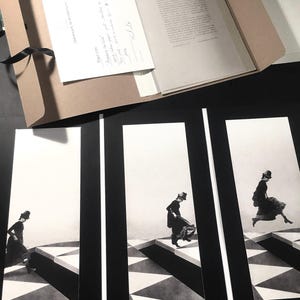 May include: Three black and white photographs of a woman in a dress and hat walking on a chequered floor. The woman is walking in a different position in each photo.