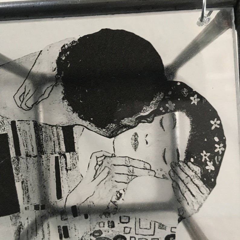 Detail of the painting The Kiss painting by Gustave Klimt printed on transparent paper and framed in a cubic metal sculpture. Handmade by Artandshadow