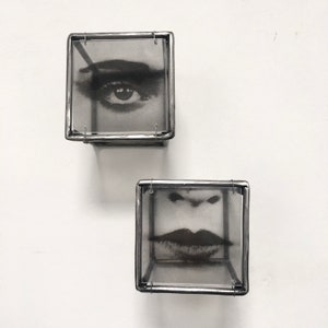 frontal photo of 3d wall art, eye and lips, in Pop art style.  Handmade from steel bar by Art and shadow