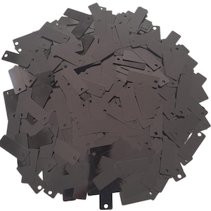 May include: A large pile of black sequins in the shape of rectangles. The sequins are scattered randomly and are all the same size and shape.