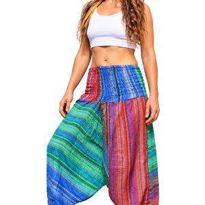 May include: Loose-fitting harem pants featuring a vibrant, multi-colored striped pattern in shades of blue, green, red, and purple. The pants have a wide, smocked elastic waistband and gathered cuffs at the ankles, creating a relaxed silhouette.