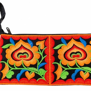 May include: A rectangular black zipped pouch featuring vibrant, multi-coloured floral embroidery. The design includes large orange and yellow flowers with green leaves and blue accents, finished with a black fabric wrist strap on the side.