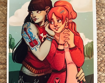 May include: A digital illustration of two women standing close together. The woman on the left has long black hair, blue and white tattoos, and is wearing a red shirt, black pants, and a black choker. The woman on the right has long pink hair, is wearing a red shirt, a pink skirt, and a pink bag with a heart on it. The background is a green field with trees and a blue sky with clouds.