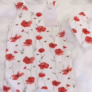 Baby girls red poppy field romper, leggings and romper dress options with matching bib, turban and headband options.