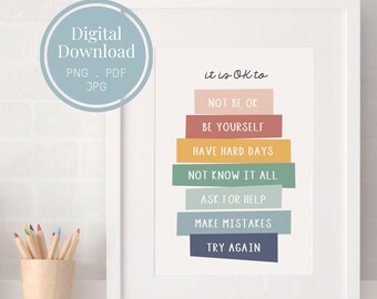Puede incluir: Una lámina de arte mural enmarcada con el texto it is OK to, seguido de bloques rectangulares de colores apilados con las frases NOT BE OK, BE YOURSELF, HAVE HARD DAYS, NOT KNOW IT ALL, ASK FOR HELP, MAKE MISTAKES y TRY AGAIN.