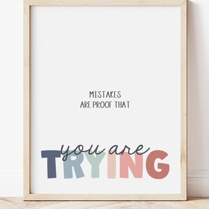 May include: A framed motivational poster with the text "Mistakes are proof that you are trying" in colorful letters. The letters are in shades of blue, green, pink, and red.