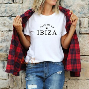 May include: White t-shirt with black text that reads "Take me to Ibiza" with a star above the word Ibiza.