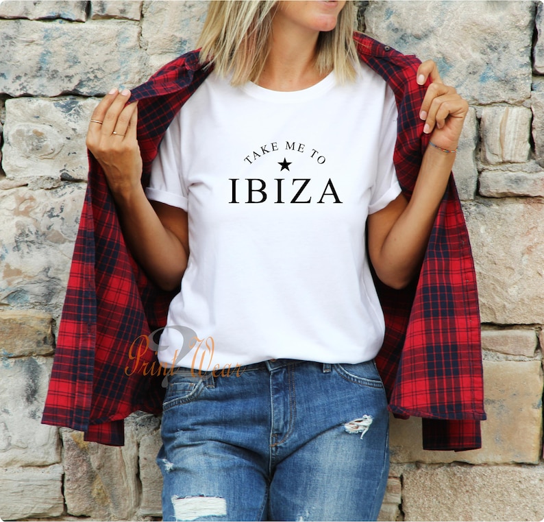 May include: White t-shirt with black text that reads "Take me to Ibiza" with a star above the word Ibiza.