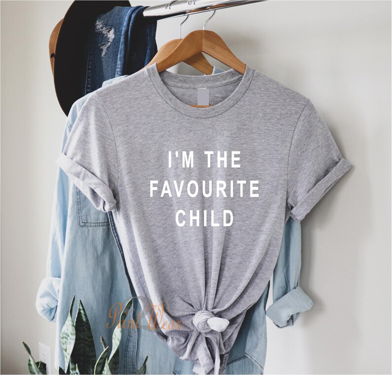 Peut inclure: Un t-shirt gris avec le texte "I'm the favourite child" imprim&eacute; en blanc sur le devant.