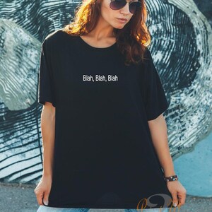 May include: A black t-shirt with the text "Blah, Blah, Blah" printed in white on the front.
