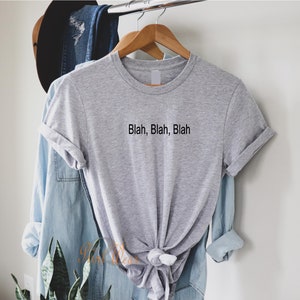 May include: A gray t-shirt with the text "Blah, Blah, Blah" printed on the front.