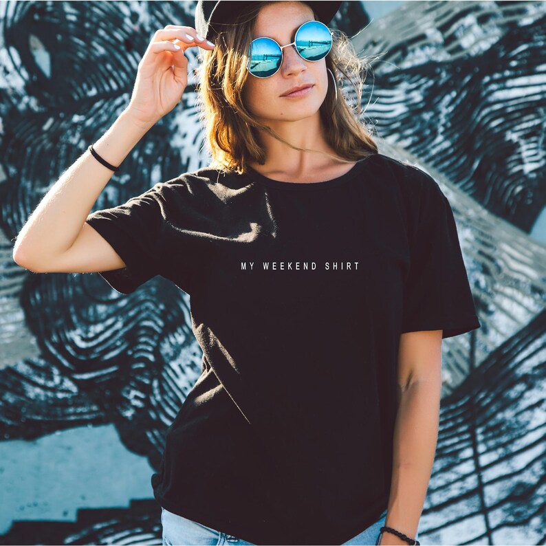 May include: A black t-shirt with the text "MY WEEKEND SHIRT" printed in white on the front.