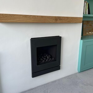 a fire place in a room with a book shelf