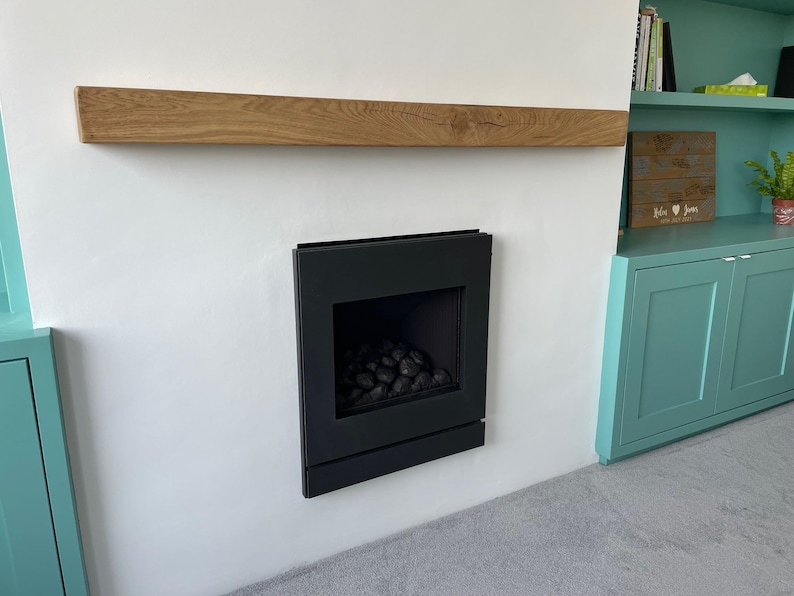 a fire place in a room with a book shelf