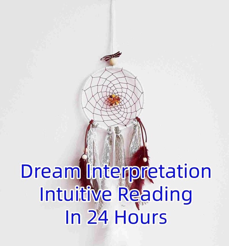 May include: White dreamcatcher with red and white string, brown feathers, and a small wooden bead at the top. The dreamcatcher has a small cluster of amber-colored stones in the center. The text "Dream Interpretation Intuitive Reading In 24 Hours" is written below the dreamcatcher.