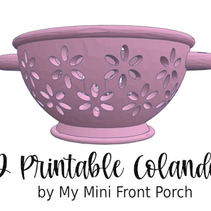 May include: A 3D printable colander in a soft pink hue, featuring a floral design of cut-out shapes. The colander has two side handles and a sturdy base. Text at the bottom reads "3D Printable Colander by My Mini Front Porch."