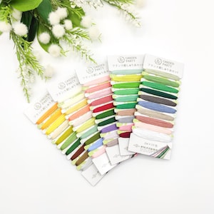 May include: A set of 10 spools of embroidery floss in various colors, including green, yellow, red, pink, and blue. The spools are labeled "Garden Party" and "フランス刺しゅう糸セット".