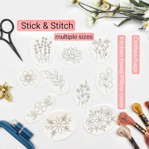 May include: A collection of embroidered floral designs in various shapes and sizes, perfect for DIY projects. The designs include lavender, a lotus flower, daisies, and other botanical elements. The text "Stick & Stitch" and "multiple sizes" are visible.