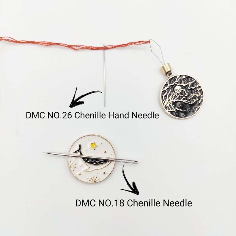 May include: Two round metal needle minders with enamel designs. One features a black night sky with trees and a moon, the other a white background with a whale and star. Includes a DMC NO.26 Chenille Hand Needle and a DMC NO.18 Chenille Needle.