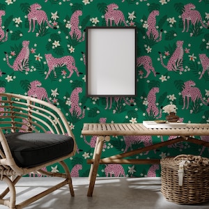 May include: A room with green wallpaper patterned with pink cheetahs. A wooden bench and a wicker chair with a black cushion are in front of the wallpaper. A woven basket and a framed blank picture are also in the room.