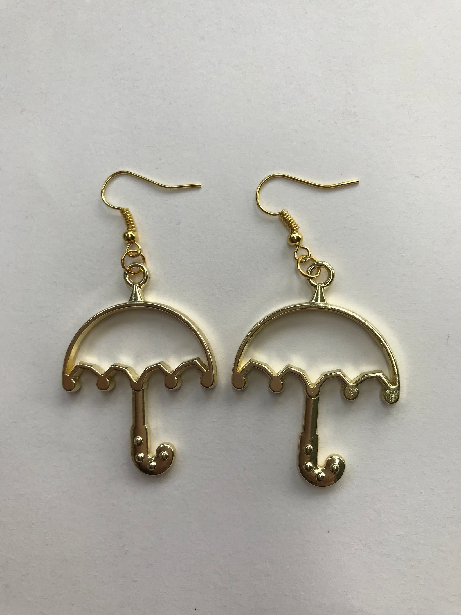 Gold metal umbrella earrings Etsy