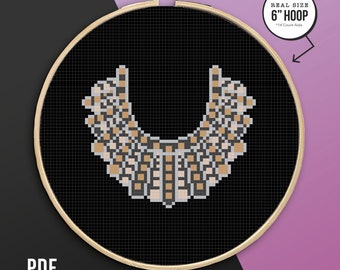 May include: A cross-stitch pattern of a brown and white necklace in a 6-inch embroidery hoop. The pattern is for 14-count Aida fabric. REAL SIZE 6" HOOP *14 Count Aida is printed on the image.