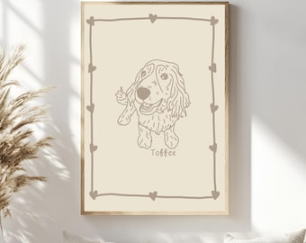 May include: A beige line drawing of a dog with the name "Toffee" written below. The drawing is framed with a light brown frame and a border of hearts.