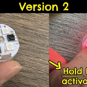 May include: A small round circuit board with four red LEDs and a black button. The text "Hold button to activate battery" is written below the circuit board.