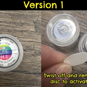 May include: A white plastic light-up disc with a rainbow colored circle and the text "OFF-ON RGB CE& Made in China". The disc has a small paper disc that needs to be removed to activate the battery.