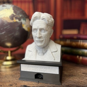 May include: A white bust of George Orwell on a black base with the text "George Orwell 1903-1950".