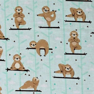 May include: A light blue fabric featuring a repeating pattern of cartoon sloths in various yoga poses. The sloths are brown with white bellies, and the background has light green tree-like lines and small black triangles.
