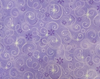May include: Purple fabric with a white glitter finish. The fabric has a repeating pattern of white swirls and small purple flowers. The fabric is accented with white stars.