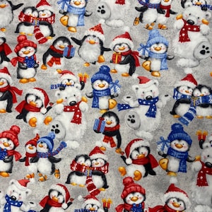 May include: A gray fabric featuring a repeating pattern of illustrated polar bears and penguins wearing red or blue winter hats and scarves, with some characters holding wrapped gifts against a textured, mottled gray background.