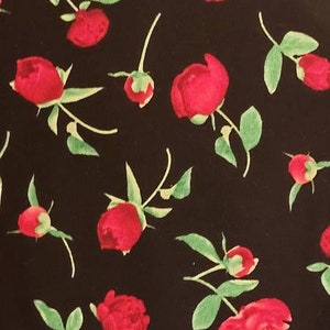 May include: Black fabric with a repeating pattern of red roses with green leaves.