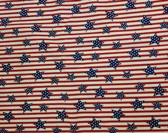 May include: Red and white striped fabric with blue stars. The fabric has a repeating pattern of red and white stripes with blue stars scattered throughout.