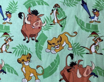 May include: A green fabric with a repeating pattern of cartoon characters from the Lion King movie. The characters include Simba, Pumbaa, Timon, and Zazu. The fabric is perfect for crafting projects like quilts, pillows, and tote bags.