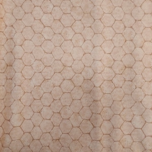 May include: A beige fabric with a brown chicken wire pattern. The fabric has a subtle texture and a slightly distressed look.