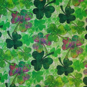 May include: A green fabric with a repeating pattern of four-leaf clovers. The clovers are in various shades of green and have a watercolor effect.