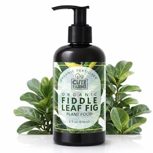 May include: A black bottle of organic fiddle leaf fig plant food with a pump dispenser. The label reads "Cute Farms" and "8 fl oz (236ml)". Green leaves are in the background.