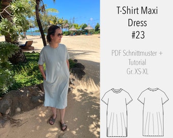 May include: A woman wearing a light blue maxi dress with short sleeves and pockets. The dress is a simple, casual style. The image also includes a line drawing of the dress pattern, with the text "T-Shirt Maxi Dress #23 PDF Schnittmuster + Tutorial Gr. XS-XL".