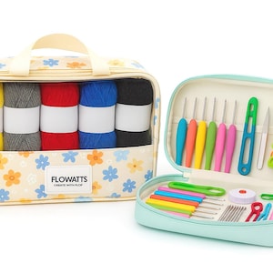 May include: A crochet kit featuring a floral patterned bag with yellow, grey, red, blue, and black yarn. A separate open teal case contains crochet hooks, needles, and accessories. The bag displays the text "FLOWATTS".