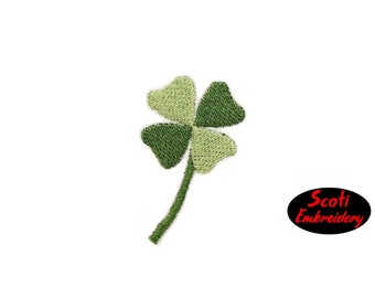 May include: A green four-leaf clover with a stem, embroidered on a white background. The image includes the text "Scoti Embroidery".