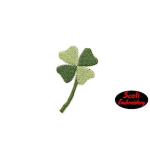 May include: A green four-leaf clover with a stem, embroidered on a white background. The image includes the text "Scoti Embroidery".
