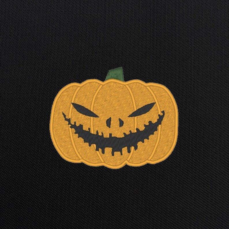 May include: A black background with an orange embroidered pumpkin with a scary black face. The pumpkin has a green stem.
