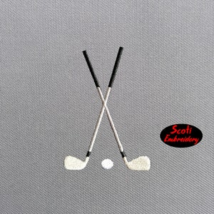 May include: Two crossed golf clubs with a white golf ball in the centre. The clubs are black and white, and the background is grey.