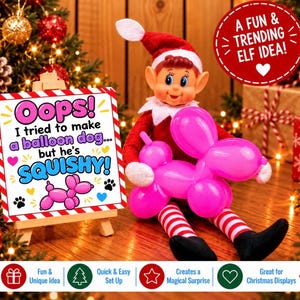 May include: A toy elf with a red hat and suit sits holding a bright pink balloon dog. Next to the elf is a small wooden easel displaying a sign that reads: Oops! I tried to make a balloon dog... but he's SQUISHY! with a pink balloon dog graphic.