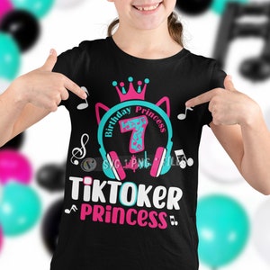May include: Black t-shirt with a pink and blue design featuring a crown, headphones, musical notes, and the text "Birthday Princess 7" and "Tiktoker Princess".