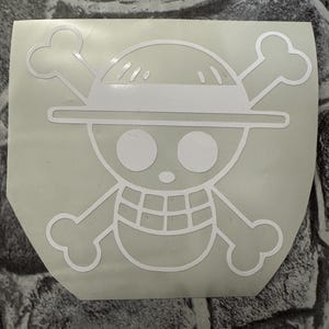 May include: White vinyl sticker of the Straw Hat Pirates Jolly Roger, a skull with a straw hat and crossbones.