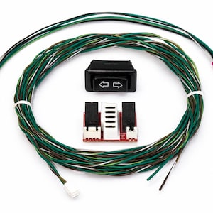 May include: A black rocker switch with white directional arrows, a red circuit board module with two black relays and a white connector, and a long wiring harness featuring multiple green, brown, and white wires with white plastic connectors.